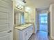 Bathroom with dual sinks, granite counters and modern fixtures, offering luxury and functionality at 4682 Grandview Glen Dr, Auburndale, FL 33823