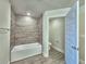 Bathroom featuring a tub with tiled wall and modern fixtures, plus a separate toilet for convenience at 4682 Grandview Glen Dr, Auburndale, FL 33823