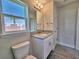 Bathroom features granite vanity, gray tile floor, and bright natural light at 4682 Grandview Glen Dr, Auburndale, FL 33823