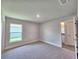 Neutral bedroom features plush carpet, natural light, and gray walls at 4682 Grandview Glen Dr, Auburndale, FL 33823