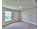 Bright bedroom with plush carpet, a window and neutral walls, creating a cozy and inviting space at 4682 Grandview Glen Dr, Auburndale, FL 33823