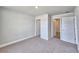 Spacious bedroom boasts two doorways and plush carpeting, offering comfort and convenience at 4682 Grandview Glen Dr, Auburndale, FL 33823