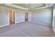 Spacious bedroom with gray walls, neutral carpeting and multiple doorways at 4682 Grandview Glen Dr, Auburndale, FL 33823