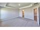 Spacious bedroom with gray walls, neutral carpeting and adjoining bathroom at 4682 Grandview Glen Dr, Auburndale, FL 33823