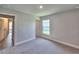 Neutral bedroom features plush carpet, natural light, and white trim at 4682 Grandview Glen Dr, Auburndale, FL 33823