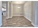 Bright dining room with wood-look flooring, stylish wainscoting, and modern chandelier at 4682 Grandview Glen Dr, Auburndale, FL 33823