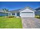 Charming single-story home features a neat lawn, brick driveway, and a two-car garage at 4682 Grandview Glen Dr, Auburndale, FL 33823