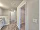 Hallway with wood floors and doors to closet and other rooms at 4682 Grandview Glen Dr, Auburndale, FL 33823