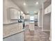 Modern kitchen with bright, white cabinetry, granite countertops and stainless steel appliances at 4682 Grandview Glen Dr, Auburndale, FL 33823