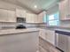 Modern kitchen with white cabinetry, stainless steel appliances, and granite countertops at 4682 Grandview Glen Dr, Auburndale, FL 33823