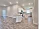 Bright kitchen with granite countertops, stainless steel appliances, island and wood-look floors at 4682 Grandview Glen Dr, Auburndale, FL 33823