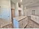 Kitchen island with granite countertops, white cabinetry, and stainless steel hardware at 4682 Grandview Glen Dr, Auburndale, FL 33823