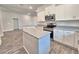 Modern kitchen featuring white cabinets, granite countertops, and stainless steel appliances at 4682 Grandview Glen Dr, Auburndale, FL 33823