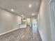 Bright, open living area featuring wood-look tile floors and neutral paint at 4682 Grandview Glen Dr, Auburndale, FL 33823