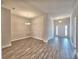 Open living space with wood-look tile flooring, decorative wall trim, and a view of the bright entryway at 4682 Grandview Glen Dr, Auburndale, FL 33823