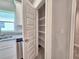 Walk-in pantry with adjustable shelving, stainless steel sink, and granite countertop at 4682 Grandview Glen Dr, Auburndale, FL 33823