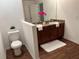 Bathroom featuring a dual sink vanity, wood floors, and pink flowers at 5514 Maggiore Blvd, Lakeland, FL 33805