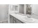 Bathroom with a double sink vanity with gray cabinets, stone countertop, and walk-in shower at 559 Sw 77Th Cir, Ocala, FL 34474