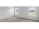 Bedroom with carpeted floors and two large windows providing plenty of natural light at 559 Sw 77Th Cir, Ocala, FL 34474