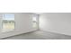 Bedroom with carpeted floors and two large windows providing views of the outside at 559 Sw 77Th Cir, Ocala, FL 34474
