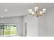 Bright dining room features a modern chandelier and sliding glass doors to backyard at 559 Sw 77Th Cir, Ocala, FL 34474