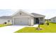 Inviting single Gathering home with a well-kept lawn, front door, and two car garage at 559 Sw 77Th Cir, Ocala, FL 34474