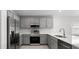 Modern kitchen with stainless steel appliances, gray cabinetry, and plenty of counter space at 559 Sw 77Th Cir, Ocala, FL 34474