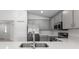 Well lit kitchen featuring quartz countertops, stainless steel appliances, and gray cabinetry at 559 Sw 77Th Cir, Ocala, FL 34474