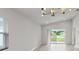 Bright living room with wood floors, vaulted ceiling, and sliding glass doors to the outdoors at 559 Sw 77Th Cir, Ocala, FL 34474