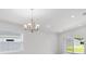 Open-concept living space with an abundance of natural light and modern chandelier at 559 Sw 77Th Cir, Ocala, FL 34474