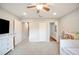 Neutral carpeted bedroom with ceiling fan with views of an en suite bathroom and walk-in closet at 5009 Hanover Ln, Lakeland, FL 33813