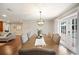 Elegant dining room with a long wood table, seating for ten, and views to the pool area at 5009 Hanover Ln, Lakeland, FL 33813