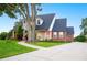 Charming home with landscaped front yard, mature trees, and inviting front porch with classic curb appeal at 5009 Hanover Ln, Lakeland, FL 33813