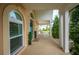 Inviting front porch with brick floor and white columns, offering a peek at the charming rocking chairs at 5009 Hanover Ln, Lakeland, FL 33813