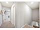 Upstairs hallway with neutral walls leading to a room with a desk and chair at 5009 Hanover Ln, Lakeland, FL 33813