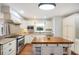 Classic kitchen with granite countertops, stainless steel appliances, and an island with a butcher block top at 5009 Hanover Ln, Lakeland, FL 33813