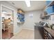 Laundry room with stainless steel front loading washer, folding shelves, and decorative touches at 5009 Hanover Ln, Lakeland, FL 33813