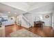 Spacious living room with hardwood floors, white staircase, and a cozy seating area with piano at 5009 Hanover Ln, Lakeland, FL 33813
