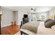 View of the main bedroom with hardwood floors, two windows, a ceiling fan, and a dark dresser at 5009 Hanover Ln, Lakeland, FL 33813