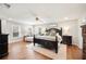 Comfortable main bedroom with a dark wood bed frame, ceiling fan, and two windows with wood flooring at 5009 Hanover Ln, Lakeland, FL 33813