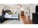 Spacious main bedroom featuring dark wood floors and furniture and an ensuite bathroom and direct access to hall at 5009 Hanover Ln, Lakeland, FL 33813