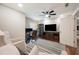Well-lit home office featuring dual monitors, a sleek desk, and a modern entertainment center with stylish furnishings at 5009 Hanover Ln, Lakeland, FL 33813