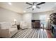 Cozy home office with plush armchairs, a modern desk setup, and a stylish striped rug for a comfortable workspace at 5009 Hanover Ln, Lakeland, FL 33813