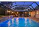 Inviting screened pool area with covered gazebo, charming brick pavers, and decorative waterfall feature at 5009 Hanover Ln, Lakeland, FL 33813