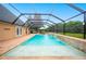 Beautiful screened-in pool area with a tanning ledge and outdoor towel rack at 5009 Hanover Ln, Lakeland, FL 33813