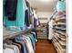 Spacious walk-in closet with ample storage, wood floors and custom shelving for shoes, clothing, and accessories at 5009 Hanover Ln, Lakeland, FL 33813