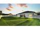 Expansive backyard with a well-maintained lawn and covered patio, ideal for outdoor enjoyment at 570 Gandhi Dr, Lakeland, FL 33813