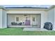 Screened patio with seating area and a view of the grassy backyard at 570 Gandhi Dr, Lakeland, FL 33813
