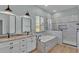 Elegant bathroom featuring a double sink vanity, a soaking tub, and a glass-enclosed shower at 570 Gandhi Dr, Lakeland, FL 33813