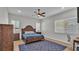 Bedroom with a wooden bed frame, blue rug, ceiling fan and natural light at 570 Gandhi Dr, Lakeland, FL 33813